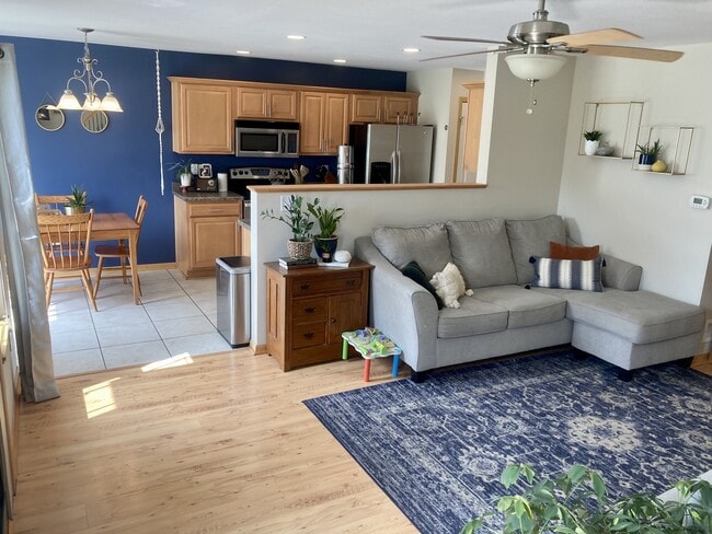 open-concept living, dining and kitchen - 906 SE Crossings Ln