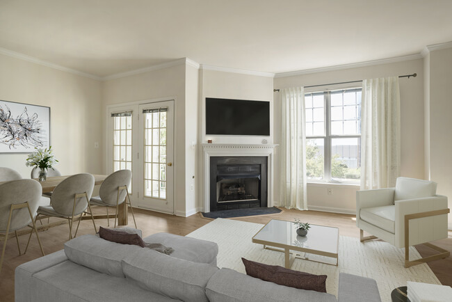 Renovated Package II living and dining area with fireplace and hard surface flooring - Avalon Reston Landing