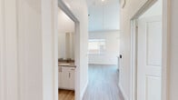 Located at Cleburne Station in Cleburne, TX, this thoughtfully designed one-bedroom, one-bathroom residence offers a clean, modern aesthetic throughout. Light wood-look flooring flows seamlessly across the entire floor plan, complementing the crisp white walls and abundant natural light.

The open-concept living, dining, and kitchen area serves as the heart of the home. The kitchen is well-appointed with white shaker-style cabinetry, granite-look countertops, a peninsula with bar seating, stainless steel appliances including a side-by-side refrigerator with ice maker, a built-in microwave, and a range. Under-cabinet lighting and a tile backsplash add polished finishing touches, while a transom window above brings in additional daylight.

The bedroom is a comfortable, light-filled retreat featuring multiple windows with neighborhood views and two generously sized closets with paneled sliding doors. The bathroom features white cabinetry, granite-look countertops, and a vanity mirror.

A dedicated laundry room houses a full-size washer and dryer with shelving above. Sliding glass doors open from the living area to a private patio overlooking a fenced yard — ideal for outdoor relaxation. Two closets provide ample storage throughout the residence.