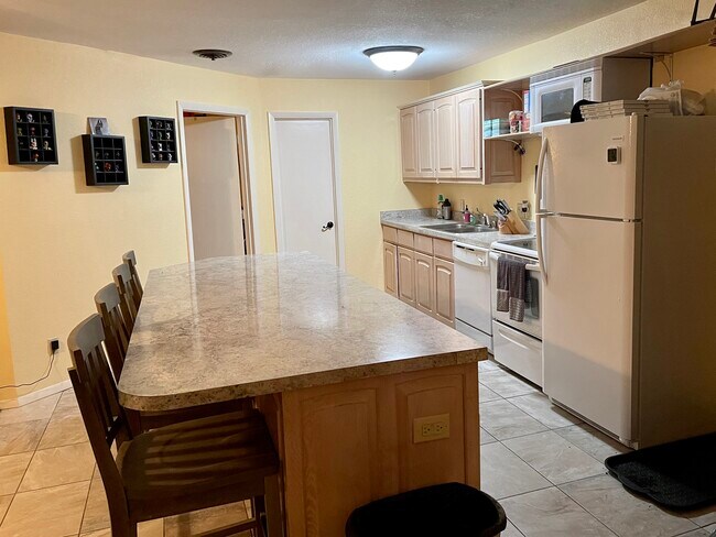 Open concept kitchen with cherrywood cabinets - 6905 SW Regional Airport Blvd
