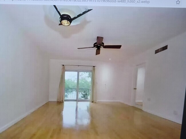 Living room opens to private balcony - 215 NE 16th Ave