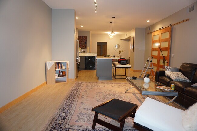 Lg. Living area with barn doors separating Bedroom/Bathroom - 111 N Hamilton St