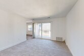 Located at 333 Lancaster Ave in Malvern, PA, this 1-bedroom, 2-bathroom residence offers a thoughtfully arranged single-floor layout with a clean, neutral aesthetic throughout. The living room is a standout space, featuring plush wall-to-wall carpeting and a large sliding glass door that opens to a private balcony, filling the room with abundant natural light and providing a seamless indoor-outdoor connection. Adjacent to the living room, a den offers versatile additional living space, ideal for a home office or sitting room. The kitchen is efficiently designed with hardwood-style flooring and ample cabinetry. The generously sized primary bedroom features soft carpeting, a dedicated closet, and a window with exterior views, creating a bright and restful retreat. Two full bathrooms serve the residence, one of which includes a full tub-and-shower combination with wood-look tile flooring. Additional highlights include two closets for storage, a dedicated laundry area for in-unit convenience, and consistent white walls and trim throughout that lend the space a clean, bright, and move-in ready feel. The overall ambiance is light, functional, and well-suited for comfortable everyday living in the heart of Malvern.