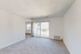 Located at 333 Lancaster Ave in Malvern, PA, this 1-bedroom, 2-bathroom residence offers a thoughtfully arranged single-floor layout with a clean, neutral aesthetic throughout. The living room is a standout space, featuring plush wall-to-wall carpeting and a large sliding glass door that opens to a private balcony, filling the room with abundant natural light and providing a seamless indoor-outdoor connection. Adjacent to the living room, a den offers versatile additional living space, ideal for a home office or sitting room. The kitchen is efficiently designed with hardwood-style flooring and ample cabinetry. The generously sized primary bedroom features soft carpeting, a dedicated closet, and a window with exterior views, creating a bright and restful retreat. Two full bathrooms serve the residence, one of which includes a full tub-and-shower combination with wood-look tile flooring. Additional highlights include two closets for storage, a dedicated laundry area for in-unit convenience, and consistent white walls and trim throughout that lend the space a clean, bright, and move-in ready feel. The overall ambiance is light, functional, and well-suited for comfortable everyday living in the heart of Malvern.