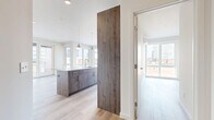 Located at 20 George St in downtown New Haven, CT, this thoughtfully designed two-bedroom, two-bathroom residence offers a contemporary open-concept layout finished with high-quality materials throughout. Light hardwood flooring runs seamlessly across the entire space, complementing the clean, neutral palette.

The kitchen is a standout feature, anchored by a large center island with a white quartz countertop, undermount sink, and pendant lighting overhead. Warm wood-tone cabinetry extends to the ceiling, paired with a marble-style tile backsplash and a full suite of stainless steel appliances. The kitchen flows directly into the living area, which is lined with floor-to-ceiling windows and a glass door offering sweeping views of the New Haven skyline.

The spacious primary bedroom features large windows with expansive city views, while the second bedroom is equally bright and well-proportioned. Both bathrooms are finished with large-format tile flooring and warm wood vanities with quartz countertops. The primary bath includes a glass-enclosed walk-in shower with subway tile surround, while the second bath provides additional flexibility. A dedicated closet completes the layout, adding practical storage to this well-appointed urban residence.