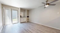 Located in Albuquerque, NM, this one-bedroom, one-bathroom unit offers a thoughtfully arranged single-floor layout that maximizes its compact footprint. The living room is bright and open, featuring light-toned luxury vinyl plank flooring, neutral walls, and a ceiling fan. A sliding glass door leads to a private balcony with outdoor views, filling the space with natural light. Built-in open shelving and a small cabinet with a countertop add functional storage and character to the living area.

The kitchen runs galley-style and is equipped with stainless steel appliances, including a refrigerator and electric range, alongside a dishwasher. White cabinetry with light stone-style countertops keeps the space clean and cohesive, while LVP flooring continues throughout.

The bedroom offers plush carpeting, a ceiling fan, and a mirrored sliding-door closet. Notably, a stacked washer and dryer unit is tucked within the closet space, providing in-unit laundry convenience. The bedroom also provides direct access to the bathroom.

The bathroom is clean and functional, featuring a full soaking tub with an overhead shower, tile surround, and LVP flooring. Neutral tones throughout the unit create a cohesive, move-in-ready atmosphere suited for comfortable everyday living.