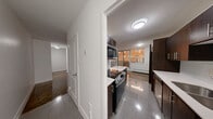 This well-proportioned two-bedroom, one-bathroom unit is located at 28 Helene St N in Mississauga, Ontario, offering a practical and comfortable single-floor layout. Throughout the living areas and bedrooms, rich parquet wood flooring adds a classic warmth and character that ties the space together cohesively.

The primary bedroom is generously sized, featuring a large sliding-door closet for ample storage, a baseboard heating unit, and a window that invites natural light and outdoor views of the surrounding neighbourhood. The second bedroom mirrors a similar layout, with its own window and baseboard heater, creating a bright and comfortable retreat.

The living area benefits from large windows that frame views of the city skyline, flooding the room with natural light and creating an open, airy ambiance. The parquet floors here are well-maintained and reflective, enhancing the sense of space.

The bathroom is finished with floor-to-ceiling taupe tile work surrounding a full soaker tub and shower combination, complemented by chrome fixtures and a mirrored wall, contributing to a clean and functional design.

A hallway connects all rooms efficiently, completing this straightforward and well-maintained layout. The unit offers a no-fuss, functional living environment in a convenient Mississauga location close to local amenities.