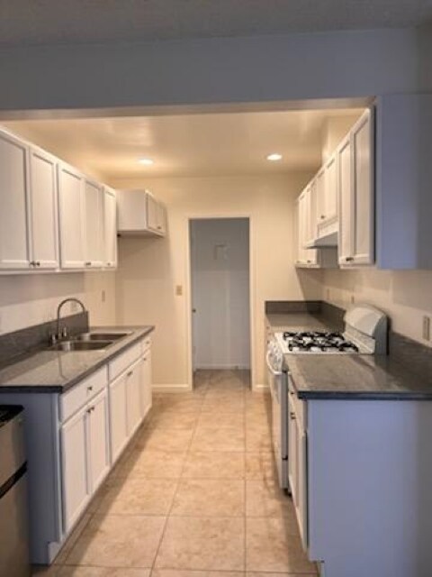 Kitchen view leads to hallway with pantry and cabinets - 120 S Sunkist St