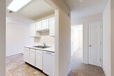 Located at 6003 S Cliff Ave. in Sioux Falls, SD, this single-floor, one-bedroom, one-bathroom unit offers a practical and well-organized layout. The living room is a generous, carpeted space filled with natural light courtesy of a sliding glass door that opens to an outdoor view, creating an airy and welcoming atmosphere. Adjacent to the living area, the kitchen and dining space are designed for functionality, featuring white cabinetry, tile flooring, a double-basin sink, a full suite of appliances including a range, microwave, refrigerator, and dishwasher, and ample counter space along both walls. The bedroom is a comfortable, carpeted retreat with a ceiling fan, a window offering natural light and outdoor views, and access to a spacious walk-in closet with built-in shelving rods. Two additional closets provide generous storage throughout the unit. The bathroom includes a full tub-shower combination with clean, white finishes and tile flooring. A textured ceiling detail is consistent throughout the unit, complementing the neutral color palette. Overall, the space presents a clean, functional design well-suited for comfortable everyday living.