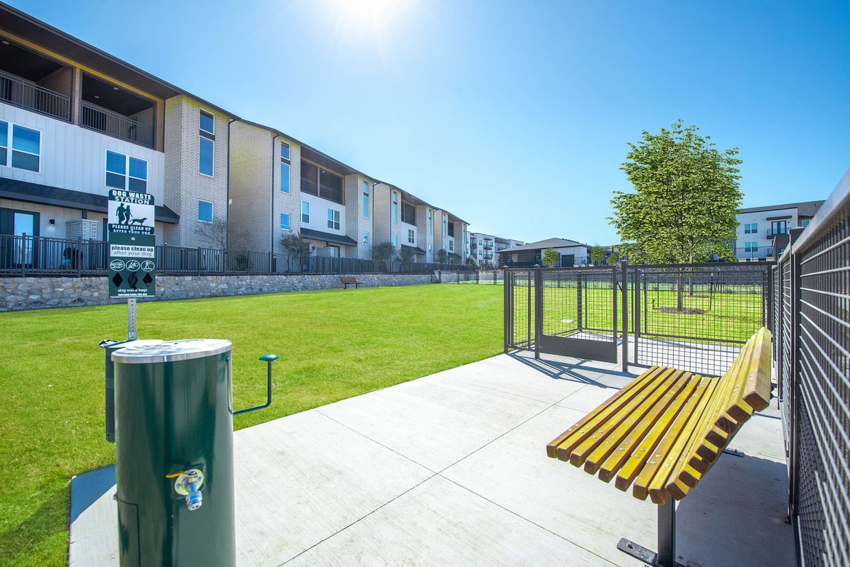 Commercial apartment dog area with pet waste station and maintained green space