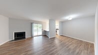Located at 3100 Sweetwater Road in Lawrenceville, GA, this one-bedroom, one-bathroom unit offers a well-organized layout with consistent wood-look flooring throughout. The open-concept main level seamlessly connects the living room and kitchen, creating an airy, cohesive living space. The living room is a standout area, featuring a classic fireplace and a sliding glass door that opens to a private balcony, filling the room with natural light and offering views of lush greenery. The kitchen is efficiently designed with white cabinetry, stone-look countertops, a subway tile backsplash, and stainless steel appliances, including an electric range with an overhead vent. A carpeted staircase with a clean white handrail leads to the upper level. The generously sized bedroom benefits from natural light through a large window with outdoor views. It is accompanied by a walk-in closet outfitted with wire shelving for ample storage. The full bathroom features a tub-shower combination with white tile surround, a white vanity with a stone-look countertop, and wood-look flooring. Neutral gray walls and crisp white trim are present throughout, contributing to a clean, modern aesthetic.