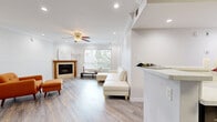 Located at 7440 N Sepulveda Blvd in Los Angeles, this thoughtfully designed one-bedroom, one-bathroom residence offers a comfortable and stylish living experience across a single floor. Light-toned wood-look flooring flows seamlessly throughout the entire unit, creating a cohesive and modern aesthetic.

The open-concept living room and kitchen serve as the heart of the home. The living area features crown molding, recessed lighting, a ceiling fan, and a classic wood-framed corner fireplace, adding warmth and character. Large windows with vertical blinds invite abundant natural light and offer views of surrounding greenery.

The kitchen is well-equipped with dark cabinetry, white quartz countertops, a wood-look tile backsplash, and a full suite of stainless steel appliances including a gas range, microwave, dishwasher, and refrigerator. A peninsula with a breakfast bar connects the kitchen to the living space.

The spacious bedroom features crown molding, a ceiling fan, a large window, and full-length mirrored sliding closet doors that enhance the sense of space. The bathroom is finished with large-format stone-look tile surrounding a soaking tub and shower combination with a built-in niche. Additional conveniences include an in-unit laundry area, a hallway, and a dedicated closet.