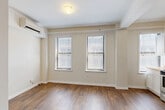 Located at 1538 Centre St in the heart of Detroit, MI, this one-bedroom, one-bathroom unit offers a well-organized layout across a single floor. The combined living and dining area is bright and open, featuring warm hardwood-style flooring and multiple windows with slatted blinds that allow natural light to filter in throughout the day. A wall-mounted mini-split unit provides efficient climate control for this shared living space.

The kitchen is thoughtfully designed with white shaker-style cabinetry, light countertops, and a full suite of stainless steel appliances including a refrigerator, electric range, microwave, and dishwasher. A window above the kitchen area adds additional natural light, enhancing the clean, functional aesthetic.

The bedroom is carpeted for comfort and features two windows that continue the home's bright character. A wall-mounted HVAC unit and baseboard heating ensure year-round comfort. Two closets provide practical storage solutions within the unit.

The bathroom is finished in clean white tones, complete with a full soaking tub and shower combination. The overall design of the unit is neutral and modern, with a consistent warm beige palette that creates a cohesive, inviting atmosphere throughout.