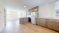 This renovated 650 square foot apartment in Cincinnati, OH, offers a perfect blend of modern convenience and efficient design. The single-floor layout comprises one bedroom, one bathroom, and an open-concept kitchen and living area. The space showcases gleaming hardwood floors throughout, creating a seamless flow and enhancing the sense of spaciousness.

The kitchen features contemporary wood cabinetry, stainless steel appliances, and a sleek countertop, ideal for culinary enthusiasts. The living room is brightened by large windows and includes a charming fireplace with a black tile surround, adding character to the space.

The bedroom, measuring 110 square feet, provides ample room for rest and relaxation. The bathroom is a standout feature, boasting a striking patterned tile floor and a modern glass-enclosed shower with marble-like tiling.

Practicality meets convenience with an in-unit laundry area, complete with a stacked washer and dryer. The apartment also includes a hallway and utility room, maximizing storage options.

Natural light floods the space through multiple windows, some offering urban views. The neutral color palette and modern fixtures create a fresh, inviting atmosphere throughout this compact yet well-designed urban dwelling.