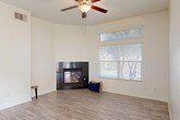 This 930 square foot single-story residence in Bakersfield, CA offers a well-designed living space with 2 bedrooms and 2 bathrooms. The home features a modern kitchen with honey-colored wood cabinetry, black countertops, and stainless steel appliances. A breakfast bar provides additional seating and separates the kitchen from the living area.

The living room is spacious and bright, featuring a gas fireplace and large windows that allow natural light to flood the space. Throughout the home, neutral-toned walls and grey wood-look flooring create a contemporary ambiance. Ceiling fans in the bedrooms and living areas provide comfort and air circulation.

Both bathrooms are well-appointed, with one featuring a combination tub/shower and the other a standalone shower. The primary bedroom, measuring 170 square feet, offers ample space and includes a closet with built-in organizers.

Additional amenities include an attached garage with an automatic door opener, providing secure parking and storage. The property's layout is efficient, with a hallway connecting the various rooms. Overall, this home presents a modern, low-maintenance living option with updated features and a neutral palette ready for personalization.