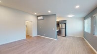Located at 333 W Queen St in Inglewood, California, this thoughtfully renovated single-floor residence showcases a clean, contemporary design throughout. Light-toned luxury vinyl plank flooring flows seamlessly across the entire unit, creating a cohesive and bright aesthetic.

The open living area features recessed lighting, a wall-mounted mini-split HVAC unit for efficient climate control, and a neutral two-tone color palette of soft gray and white that enhances the sense of space. This area connects naturally to the kitchen, which is a true standout. The kitchen is equipped with bold navy-blue lower cabinetry, glass-front upper cabinets, a mosaic tile backsplash, white quartz countertops, and a full suite of stainless steel appliances including a refrigerator, dishwasher, electric range, and over-the-range microwave.

The bedrooms are well-proportioned, each featuring a ceiling fan with light fixture, natural light from windowed walls fitted with blinds, and the same consistent flooring. The bathrooms are updated with dark-finish vanities, mosaic tile accents, and framed mirrors. One bathroom provides convenient access to an in-unit stacked washer and dryer. The layout is efficient and functional, offering comfortable, modern living in a well-appointed Inglewood location.