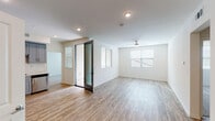 This single-floor residence at 5377 Quail Run Rd in Riverside, California offers a clean, contemporary design with an open and airy layout throughout. Light-toned luxury vinyl plank flooring runs seamlessly across the main living areas, complementing the crisp white walls and recessed lighting that keep the space feeling bright and inviting. The spacious living area features multiple windows with blinds that allow for natural light control, along with a ceiling fan for added comfort.

The kitchen is a standout feature, outfitted with stylish grey shaker cabinetry, white quartz countertops, a white subway tile backsplash, and a full suite of stainless steel appliances including a refrigerator, gas range, built-in microwave, and dishwasher. A deep undermount sink with a modern brushed nickel faucet completes the well-designed cooking space.

The layout includes a walk-in closet with built-in shelving and carpeted flooring, providing generous storage. Two bathrooms serve the residence: one features a wide vanity with an undermount sink and a glass-enclosed walk-in shower with tiled walls, while the second offers a tub-shower combination with matching tile surround and a grey vanity. Both bathrooms continue the home's cohesive, modern aesthetic with wood-look flooring and clean white finishes throughout.