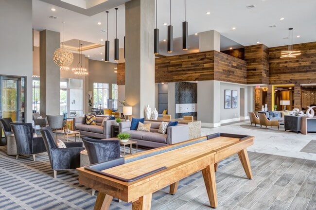 Spacious clubhouse with stylish seating, games, and elegant design—perfect for relaxing or socializing. - The Heights at Goose Creek Village