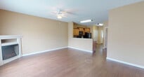 Located at 2000 Hartmann Plantation Ct in Lebanon, Tennessee, this two-floor home offers a thoughtfully designed layout with a warm, neutral color palette throughout. The main living area features durable hardwood-style flooring, a ceiling fan, and a bright window that fills the space with natural light, creating an open and welcoming atmosphere. The kitchen is a functional highlight, showcasing rich wood cabinetry with crown molding detail, granite countertops, a mosaic tile backsplash, and black appliances including a range, over-the-range microwave, refrigerator, and dishwasher. A breakfast bar connects the kitchen to the living area, enhancing the open-concept flow. The bedrooms are carpeted and include ceiling fans and windows that invite ample daylight. The bathrooms are finished with granite-topped vanities and warm wood cabinetry. The primary bathroom features a dual-sink vanity and hardwood-style flooring, while additional bathrooms are equipped with tub-shower combos and matching granite counters. Textured walls and clean white trim are consistent design elements found throughout the home, contributing to a cohesive and polished interior aesthetic.