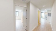Located in Oakland Park, Florida, this modern residence offers four bedrooms and two bathrooms across a thoughtfully designed single-floor layout. Light wood-tone flooring flows throughout, complementing the clean white walls and creating a bright, airy atmosphere.

The kitchen is a standout feature, showcasing two-tone cabinetry with warm wood lower cabinets and crisp white upper cabinets, a penny-tile mosaic backsplash, white quartz countertops, and a full suite of stainless steel appliances. The open living area is bathed in natural light through floor-to-ceiling black-framed windows and sliding glass doors that open to a balcony with sweeping views of the surrounding greenery and Oakland Park skyline.

The bedrooms are clean and versatile, with light flooring and white walls offering a neutral canvas. The primary bedroom features direct balcony access through large sliding glass doors, further maximizing the connection to the outdoors. The two bathrooms are finished in a contemporary style — one features a wood-toned vanity with a white countertop and a glass-enclosed shower, while the other includes a tiled tub-shower combination with a sleek glass partition. The overall design is minimal, modern, and filled with natural light.