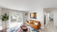 Located at 1314 Wharton Dr in Newark, Delaware, this thoughtfully laid-out one-bedroom, one-bathroom residence offers a practical and comfortable single-floor living experience. The bright living room serves as the heart of the home, featuring light wood-tone flooring, recessed lighting, and a large sliding glass door that fills the space with natural light and provides outdoor views. A pass-through window connects the living area seamlessly to the kitchen, enhancing the open feel. The kitchen is well-appointed with warm honey-toned cabinetry, granite-style countertops, stainless steel appliances including a dishwasher, range, and refrigerator, plus a window above the sink for added brightness. The dedicated dining area is a cozy, defined nook with vertical shiplap-style walls and crown molding. The office features board-and-batten wall paneling and a natural light-filled window, making it an ideal workspace. The spacious bedroom offers two louvered bi-fold closets and light wood flooring, providing ample storage. The clean, neutral-toned bathroom completes the layout. Throughout, light wood-tone flooring and a soft, neutral color palette create a cohesive and inviting ambiance.