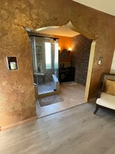 Zen style bathroom with rock wall - 163 California Ave