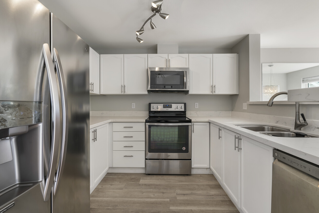 Kitchen with stainless steel appliances and quartz countertops - 9910 NE 137th St