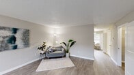 Located at 1220 Meredith Dr in Columbia, SC, this two-story home offers four bedrooms and two bathrooms thoughtfully distributed across two floors. The main level features a welcoming living room with neutral-toned walls, light wood-look flooring, and a textured ceiling, creating a bright and comfortable gathering space. The kitchen is well-appointed with white cabinetry, light countertops, and a full suite of stainless steel appliances, including a dishwasher, range, microwave, and refrigerator. A dining nook adjacent to the kitchen benefits from a large window that lets in ample natural light and offers views of the surrounding greenery. Upstairs, the bedrooms feature plush carpeting, ceiling fans, and generous closet space — the primary bedroom includes a walk-in closet, while secondary bedrooms offer built-in shelf closets. Each bedroom is well-lit by windows with slatted blinds. The bathrooms are clean and functional, featuring full tub-shower combinations. Throughout the home, a consistent neutral color palette and practical finishes contribute to a cohesive, move-in-ready atmosphere. Two hallways connect the spaces across both levels, ensuring an efficient and accessible layout throughout.
