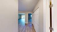 Located at 303 Greenwich Ave in Warwick, Rhode Island, this one-bedroom, one-bathroom unit offers a well-organized, single-floor layout designed for comfortable everyday living. The open kitchen and living room combination serves as the heart of the home, where the kitchen stands out with rich dark espresso cabinetry, granite-style countertops, and a full suite of stainless steel appliances including a gas range, dishwasher, and refrigerator. Light wood-style flooring ties the kitchen seamlessly into the living area, which is generously proportioned and features a sliding glass door that fills the room with natural light and provides direct views of the landscaped grounds and parking area beyond. A ceiling fan and wall-unit air conditioning add to the practicality of the living space. The bedroom is a comfortable retreat finished with soft wall-to-wall carpeting, a large window with vertical blinds inviting in natural light, and baseboard heating. A dedicated closet provides convenient storage. The bathroom features a full soaking tub and shower combination with clean white surroundings and chrome fixtures. Throughout the unit, neutral wall tones and consistent finishes create a cohesive, move-in-ready ambiance suited for a range of lifestyles.