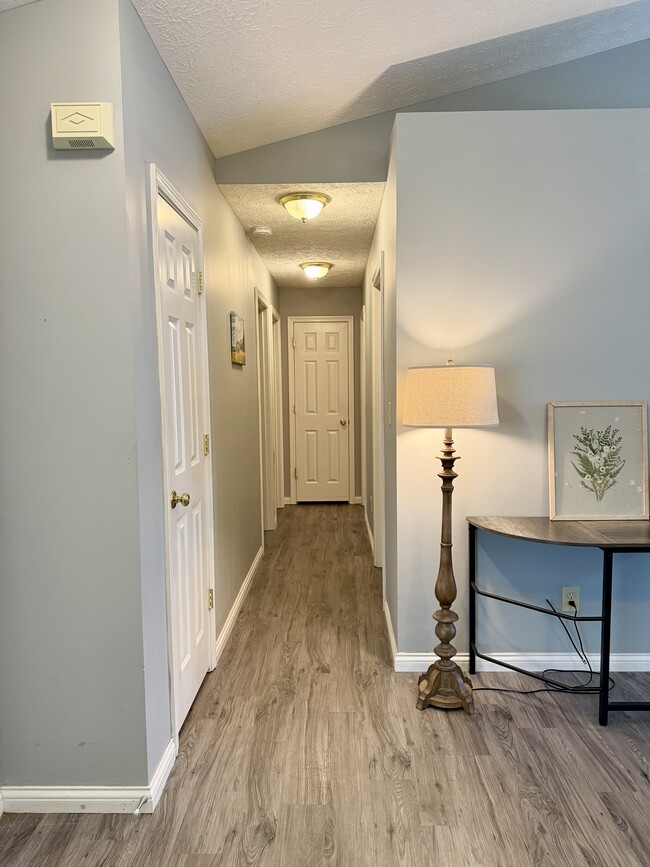 hallway to the 2 other bedrooms and full bath - 1402 Crusade Dr