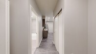 Located at 8445 Pacific Ave in Tacoma, Washington, this modern single-floor unit is part of a contemporary multi-building residential community with on-site parking. The interior showcases a cohesive neutral palette, recessed lighting, and durable wood-look tile flooring in the main living areas, complemented by plush carpet in the bedrooms.

The kitchen is a standout feature, equipped with sleek concrete-finish cabinetry, stainless steel appliances including a refrigerator, range, and over-the-range microwave, and a peninsula with a white quartz countertop and undermount sink — ideal for both cooking and casual dining. Adjacent to the kitchen, a dedicated dining area offers natural light through a window with blinds and provides comfortable space for a full dining set.

The living room is bright and welcoming, featuring a large window that fills the space with natural light. Two well-appointed bedrooms include recessed lighting, soft carpeting, and sliding-door closets for ample storage. An in-unit stacked washer and dryer adds everyday convenience. The bathroom is finished with large-format tile surround in the tub/shower, a white quartz vanity, and brushed nickel fixtures. A clean, well-lit hallway with a sliding storage closet connects all rooms efficiently.