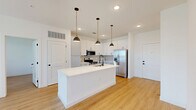 Located on N Marksheffel Rd in Colorado Springs, CO, this thoughtfully designed single-story home offers 2 bedrooms, 3 bathrooms, and a well-utilized floor plan with clean, contemporary finishes throughout. Light wood-look flooring flows seamlessly across the entire residence, enhancing its bright and cohesive aesthetic.

The open-concept kitchen and living area serves as the heart of the home. The kitchen features white shaker cabinetry, a geometric hexagonal tile backsplash, crisp white quartz countertops, stainless steel appliances including a French door refrigerator and electric range, and a large center island with an undermount sink and stylish pendant lighting. The living area is bathed in natural light from multiple windows and includes a ceiling fan, with direct access to an outdoor area via a glass door.

Both bedrooms are generously proportioned, each with large windows offering outdoor views, ceiling fans, and warm wood-look flooring. The primary bedroom connects to a well-appointed en-suite bathroom featuring a backlit LED vanity mirror, white cabinetry with matte black hardware, wood-tone accent tile, and a soaking tub. Three dedicated closets provide ample storage. A convenient in-unit laundry room completes this polished, move-in-ready home.
