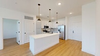 Located on N Marksheffel Rd in Colorado Springs, CO, this thoughtfully designed single-story home offers 2 bedrooms, 3 bathrooms, and a well-utilized floor plan with clean, contemporary finishes throughout. Light wood-look flooring flows seamlessly across the entire residence, enhancing its bright and cohesive aesthetic.

The open-concept kitchen and living area serves as the heart of the home. The kitchen features white shaker cabinetry, a geometric hexagonal tile backsplash, crisp white quartz countertops, stainless steel appliances including a French door refrigerator and electric range, and a large center island with an undermount sink and stylish pendant lighting. The living area is bathed in natural light from multiple windows and includes a ceiling fan, with direct access to an outdoor area via a glass door.

Both bedrooms are generously proportioned, each with large windows offering outdoor views, ceiling fans, and warm wood-look flooring. The primary bedroom connects to a well-appointed en-suite bathroom featuring a backlit LED vanity mirror, white cabinetry with matte black hardware, wood-tone accent tile, and a soaking tub. Three dedicated closets provide ample storage. A convenient in-unit laundry room completes this polished, move-in-ready home.