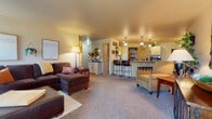 Located at 3910 Mount View Ave in Weston, Wisconsin, this single-floor unit offers a functional and comfortable layout with a warm, welcoming aesthetic. The exterior entrance is framed by brick construction, with a covered entryway that leads directly into the living space.

The open-concept main living area seamlessly connects the living room, dining space, and kitchen. The living room features plush carpeting, ample natural light, and a door providing direct access to a private patio. The kitchen is outfitted with light wood cabinetry, a dark granite-style countertop, a breakfast bar with seating, pendant lighting, recessed ceiling lights, and a dedicated walk-in pantry for generous storage. Adjacent to the kitchen, a cozy dining nook accommodates a round table beneath a chandelier, with tile flooring and a nearby closet.

The bedrooms are carpeted and well-sized, each with natural light from windows. One bedroom includes a ceiling fan, while another features warm-toned walls and ample dresser space. The bathroom offers a tub-shower combination, built-in shelving, a vanity with storage, and tile flooring. Throughout, the unit maintains a cohesive, neutral palette that creates a comfortable and inviting atmosphere.