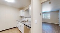 Located at 701 White Spar Rd in Prescott, Arizona, this one-bedroom, one-bathroom unit offers a well-designed, single-story layout that makes efficient use of its space. The kitchen is a standout feature, showcasing white shaker cabinetry, granite countertops, a white subway tile backsplash, and a full suite of stainless steel appliances including a refrigerator, stove, built-in microwave, and dishwasher. An arched pass-through connects the kitchen to the combined living and dining area, which is finished with warm wood-style flooring and receives natural light through blinds-fitted windows. The bedroom is a comfortable size, equipped with a ceiling fan, a window with outdoor views, and two closets providing ample storage. The bathroom mirrors the kitchen's finishes with granite countertops, white cabinetry, a large vanity mirror, and a full bathtub and shower combination, all set on matching wood-style flooring. Throughout the unit, neutral warm-toned walls and consistent flooring create a cohesive and clean aesthetic. The overall ambiance is bright, modern, and move-in ready, offering practical living in the heart of Prescott.