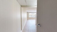 Located in San Diego, CA 92127, this studio offers a practical and efficiently designed single-floor layout. The main living area is finished with warm, light-toned wood flooring that extends throughout, creating a cohesive and clean aesthetic. Neutral beige walls and a textured ceiling complement the open feel of the space. A large window allows natural light to fill the room while offering views of the surrounding neighborhood, and a wall-mounted mini-split air conditioning unit ensures year-round comfort.

The kitchenette is neatly integrated into the living space, featuring white cabinetry, a compact sink, under-counter refrigerator, and a microwave — providing all the essential cooking and storage needs in a streamlined footprint. An entry door is conveniently positioned adjacent to the kitchenette area.

The bathroom is well-appointed with accessibility in mind, showcasing light tile flooring, a granite-topped vanity with a framed mirror, a wall-mounted medicine cabinet with glass shelving, and stainless steel grab bars near the toilet and shower area. The open vanity design further enhances accessibility. Overall, this studio delivers a functional and comfortable living environment ideal for those seeking an efficient space in San Diego.