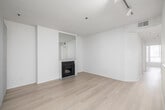 This 800 square foot apartment in Los Angeles offers a thoughtful layout maximizing space and functionality. The single-floor plan includes a generously sized 230 square foot primary bedroom, providing ample living space. The open concept design seamlessly integrates the kitchen and living room, creating a spacious feel throughout.

The living area is anchored by a sleek fireplace, adding both warmth and a focal point to the room. Large windows and a balcony access point flood the space with natural light, enhancing the apartment's airy ambiance. Light wood flooring runs throughout, unifying the design and adding a modern touch.

The updated kitchen boasts white cabinetry, contrasting dark granite countertops, and stainless steel appliances. A skylight above brings additional brightness to the cooking space. The U-shaped layout offers efficient workflow and plenty of storage.

A dedicated closet area provides valuable storage space, while the bathroom, though not pictured, likely continues the apartment's modern aesthetic. The neutral color palette throughout allows for versatile decorating options, making this apartment a blank canvas for personal style.