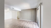 Located at 200 S Pantano Rd in Tucson, AZ, this single-floor, 2-bedroom, 2-bathroom residence offers a clean, modern aesthetic throughout. Wood-style flooring flows consistently across all rooms, complemented by neutral gray and white tones that create a bright, cohesive atmosphere.

The living room is a comfortable, open space featuring a sliding glass door that opens to a private balcony, allowing natural light to fill the room. The galley-style kitchen is efficiently designed with white shaker cabinetry, granite-style countertops, a double sink, and black appliances including a range, refrigerator, and dishwasher. A pendant light fixture illuminates the adjacent dining area.

The primary bedroom is a well-proportioned retreat with a sliding closet door and direct access to a hallway leading to the rest of the unit. The second bedroom features a large window with vertical blinds, bringing in natural light. Both bedrooms are served by their own bathrooms, each outfitted with white cabinetry, granite-style countertops, a tub-shower combination, and wood-style flooring. A dedicated entrance and hallway connect the rooms, with additional closet storage available throughout. The overall layout is functional and thoughtfully organized.