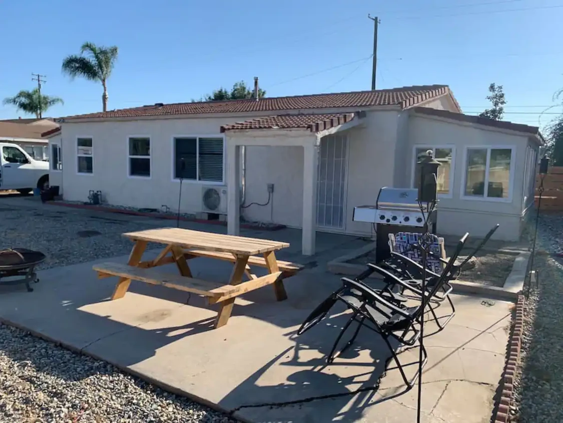 Outside Patio, Fire pit with BBQ with the home in the background. - 12964 Roswell Ave