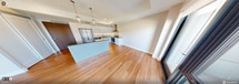 Located at 1325 Riverbend Rd in London, Ontario, this contemporary single-floor unit offers 1,010 square feet of thoughtfully designed living space across 3 bedrooms and 2 bathrooms. Warm hardwood-style flooring flows consistently throughout, complementing the clean, neutral palette of the interiors.

The open-concept kitchen and living area serves as the heart of the home. The kitchen is outfitted with stainless steel appliances including a refrigerator, dishwasher, and range, paired with sleek white cabinetry, grey quartz countertops, a subway tile backsplash, and a central island beneath two globe pendant lights. Large floor-to-ceiling windows and sliding glass doors in the living area flood the space with natural light and open to a balcony with views of the surrounding Riverbend community.

The bedrooms are bright and functional, with several featuring direct outdoor access or large windows overlooking the neighbourhood. The primary bedroom measures 130 square feet and includes a sliding double closet. Both bathrooms showcase elegant marble-style tile work — one features a soaker tub with brushed gold fixtures, while the other offers a frameless walk-in shower with a wood-accented vanity and brushed nickel hardware.