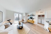 Located at 2501 Avant Ave in Ann Arbor, Michigan, this thoughtfully designed one-bedroom, one-bathroom residence offers a bright and modern living experience. The open-concept layout seamlessly connects the kitchen, dining area, and living room, creating an airy, cohesive space bathed in natural light.

The kitchen is outfitted with crisp white cabinetry, granite countertops, stainless steel appliances — including a refrigerator, range, microwave, and dishwasher — and a central island with pendant lighting, ideal for both cooking and casual dining. Light wood-style flooring runs throughout the main living areas, enhancing the clean, contemporary aesthetic.

The living room is generously proportioned with large sliding glass doors that open onto a private balcony, bringing in abundant natural light and outdoor access. An in-unit washer and dryer is conveniently situated off the living area.

The bedroom features plush carpeting, a large window with exterior views, and easy access to a closet. The full bathroom includes a tub-shower combination and built-in shelving for storage.

A welcoming entry hallway completes the layout. Clean white walls, recessed lighting, and modern finishes throughout give this residence a polished, move-in-ready feel well-suited to Ann Arbor living.