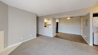 Located at 742 Western Dr in Colorado Springs, Colorado, this single-floor residence offers a well-organized layout designed for comfortable everyday living. The open living and dining area is finished with soft carpet flooring and neutral gray walls, creating a bright and welcoming atmosphere. A tiled fireplace anchors one end of the living room, while a sliding glass door with vertical blinds provides access to the outdoors and fills the space with natural light. A wall-mounted mini-split unit ensures year-round climate control. The kitchen features crisp white shaker-style cabinetry with matte black hardware, sparkling quartz countertops, and stainless steel appliances including a GE electric range with overhead ventilation. A pass-through window connects the kitchen to the main living area, enhancing the open feel. The bedrooms are carpeted and well-lit by multiple windows that bring in ample natural light. The primary bedroom includes a walk-in closet with built-in shelving and direct access to a private bathroom. The bathrooms are finished with wood-look flooring, tiled tub-shower combinations, and light quartz vanity surfaces. Textured ceilings are consistent throughout the home, adding a classic touch to the overall design.