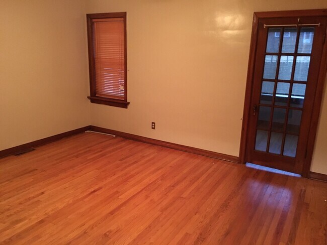 Bedroom 1. French door leads to Den / Sun Room. - 6000 Carlsbad Avenue