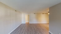 Located at 1600 Golden Horseshoe Cir in Morrisville, NC, this single-floor residence offers a well-organized layout with a variety of functional living spaces. The living area is a standout, highlighted by a classic brick fireplace flanked by two windows that flood the room with natural light. Durable wood-look flooring extends throughout the main living and dining areas, contributing to a clean, cohesive aesthetic with neutral-toned walls throughout.

The kitchen is thoughtfully designed with white shaker-style cabinetry, light countertops, and stainless steel appliances, including an electric range with overhead microwave. A window above the counter provides natural light and an outdoor view, enhancing the workspace.

The bedrooms are carpeted for comfort, each featuring neutral walls and windows. The primary bedroom offers dual closets with hanging rods, providing generous storage. Additional bedrooms are well-proportioned with their own closet access and natural light.

Two full bathrooms serve the home, each equipped with a tub-shower combination, white vanity with light countertops, and windows for ventilation and natural light. The overall design of this residence is practical and move-in ready, with consistent finishes that create a harmonious and inviting atmosphere throughout.