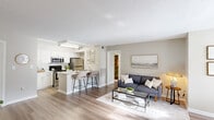 Located at 300 Palmetto Park Blvd in Lexington, SC, this single-floor residence offers a thoughtfully designed open-concept layout across two bedrooms and two bathrooms. The living area flows seamlessly into the kitchen and dining spaces, all finished with warm-toned luxury vinyl plank flooring throughout. The kitchen is a functional centerpiece, featuring white shaker cabinetry, a subway tile backsplash, marble-style countertops, stainless steel appliances, and a peninsula with bar seating — ideal for casual dining or entertaining. Adjacent to the kitchen, the dedicated dining area is bright and airy, with multiple windows offering outdoor views and a ceiling fan overhead. The spacious primary bedroom includes a ceiling fan and ample closet space, while the second bedroom provides a comfortable and cozy retreat. Two full bathrooms feature clean, neutral finishes, with one including a tub/shower combo, a white vanity with a marble-style countertop, and a large mirror. Two closets provide generous storage throughout. The overall palette of soft neutral tones, textured ceilings, and consistent flooring creates a cohesive, move-in-ready ambiance well-suited to everyday living.