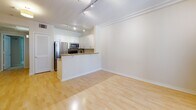 Located at 8020 W Manchester Ave in the Playa del Rey neighborhood of Los Angeles, this single-floor unit offers a thoughtfully designed open-concept layout. The living area is anchored by a granite-surround fireplace and flows seamlessly into the kitchen and dining space, all finished with warm hardwood-style flooring throughout. Crown molding and track lighting add refined touches to the bright, airy interior.

The kitchen is well-appointed with white shaker-style cabinetry reaching to the ceiling, granite countertops with a complementary tile backsplash, and a full suite of stainless steel appliances including a refrigerator, range, microwave, and dishwasher. A peninsula with a double sink provides additional prep space and casual seating.

The bedroom features plush carpeting, a wall of mirrored sliding closet doors offering generous storage, and a sliding glass door that opens to a private outdoor area, allowing natural light to fill the room. The bathroom is finished with tile flooring, white cabinetry with granite countertops, and a shower-tub combination with a glass sliding door. A dedicated hallway with louvered doors provides additional storage or utility space, completing this practical and comfortable single-level home.