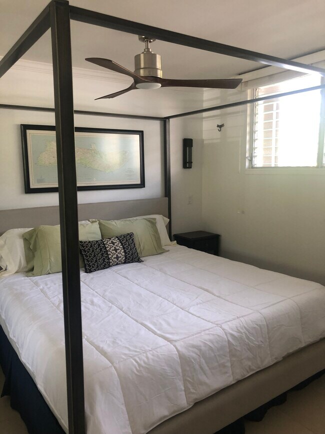 King size canopy bed with nightstands with lamps ceiling fan map of Molokai - 7142 Kamehameha V Hwy