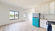 Located at 435 SW Sixth St in Miami's vibrant Brickell neighborhood, this 2-bedroom, 1-bathroom unit offers a clean, modern aesthetic across a single floor. The interior is finished with light wood-style luxury vinyl flooring throughout, crisp white walls, and white baseboards that create a bright, cohesive look.

The spacious primary bedroom is the standout room, featuring large black-framed windows that flood the space with natural light and offer open views of the surrounding Miami skyline and treetops. A wall-mounted mini-split air conditioning unit ensures efficient climate control. Bifold closet doors and a dedicated electrical panel are neatly integrated into the room.

The second bedroom is well-proportioned and equally light-filled, also featuring a black-framed window with outdoor views, making it suitable as a guest room or home office.

The shared bathroom showcases large-format marble-look porcelain tile flooring and matching wall tile in the tub/shower surround, lending an elegant, contemporary feel. The all-white palette enhances the sense of cleanliness and space.

The unit's open layout, modern finishes, and abundant natural light make it a functional and stylish residence in one of Miami's most sought-after urban neighborhoods.