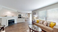 Located at 2223 Craigside Dr. in Columbus, Ohio, this two-story, 2-bedroom, 2-bathroom home is thoughtfully designed across two floors. The main level offers a generous open-concept layout where the living room, dining area, and kitchen flow seamlessly together. The living room features warm hardwood-style flooring, large windows with natural light, and a cozy fireplace. The kitchen is well-appointed with crisp white shaker cabinetry, dark granite countertops, black appliances including a gas range and built-in microwave, track lighting, and a peninsula that doubles as a breakfast bar. Adjacent to the kitchen, the dining area accommodates a full-sized table beneath a ceiling fan. A dedicated laundry room is conveniently located on the main floor. Upstairs, the primary bedroom impresses with vaulted ceilings, plush carpet, multiple windows, and a closet. The second bedroom is equally comfortable with neutral tones, carpet flooring, and ample natural light. Both bathrooms are finished with dark granite vanity tops and clean white fixtures; one features a tub-shower combination. Additional storage is provided through four closets spread across both floors, making this home as functional as it is welcoming.
