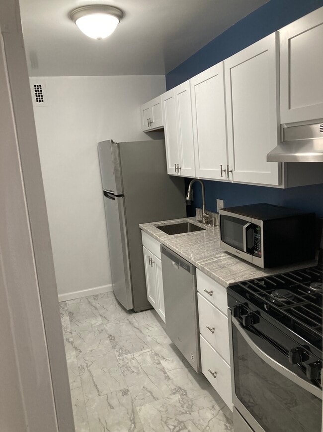 Kitchen is to the Left of Entrance Door - 1330 New Hampshire Ave NW
